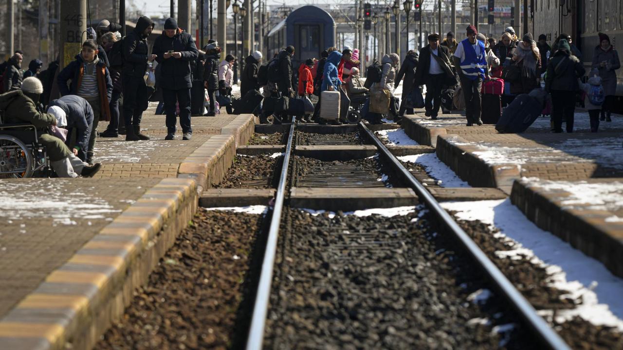 Refugees fleeing the war from neighboring Ukraine switch platforms at the Suceava railway station, in Suceava, Romania, Saturday, March 12, 2022. (AP Photo/Andreea Alexandru)