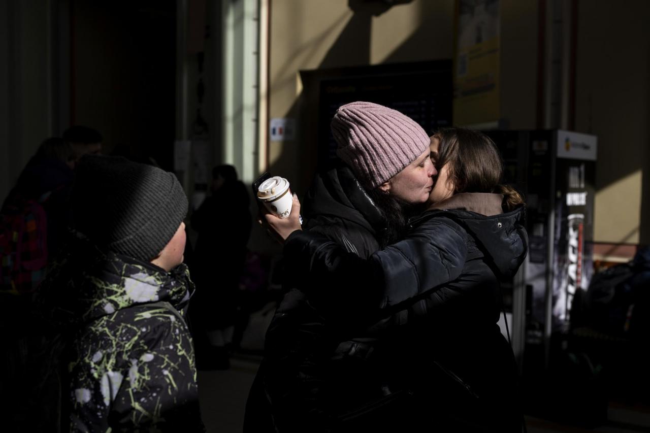 Tatianna, left, who fled the war from Ukraine reunites with her daughter Katerina who is living in Poland as she arrives at the Przemysl train station, southeastern Poland, on Saturday, March 12, 2022. (AP Photo/Petros Giannakouris)