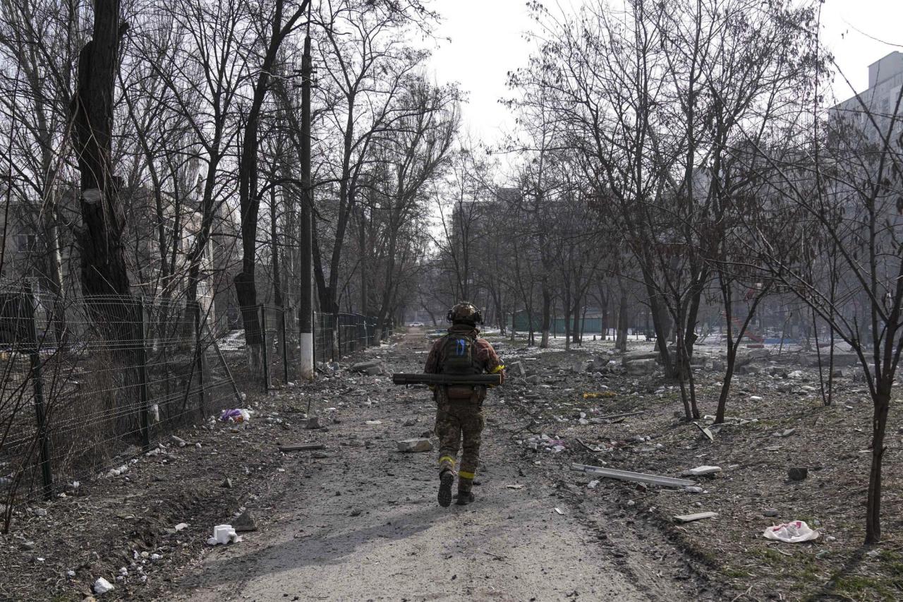 A Ukrainian serviceman walks near the position he was guarding in Mariupol, Ukraine, Saturday, March 12, 2022. (AP Photo/Evgeniy Maloletka)